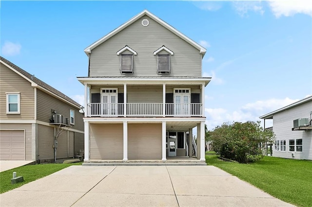 view of front facade featuring a balcony, a front yard, covered porch, concrete driveway, and central AC unit