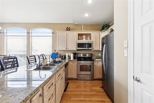 kitchen featuring appliances with stainless steel finishes, a sink, recessed lighting, light wood-type flooring, and light brown cabinets
