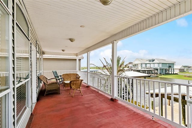balcony featuring a water view and a residential view