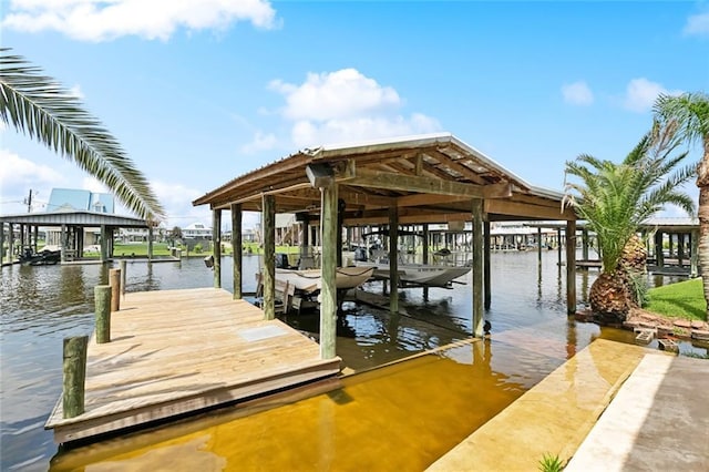 dock area featuring boat lift and a water view