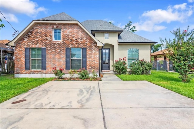 3225 Delaware Ave, Kenner, LA 70065 - view of front of property with a shingled roof, brick siding, and stucco siding