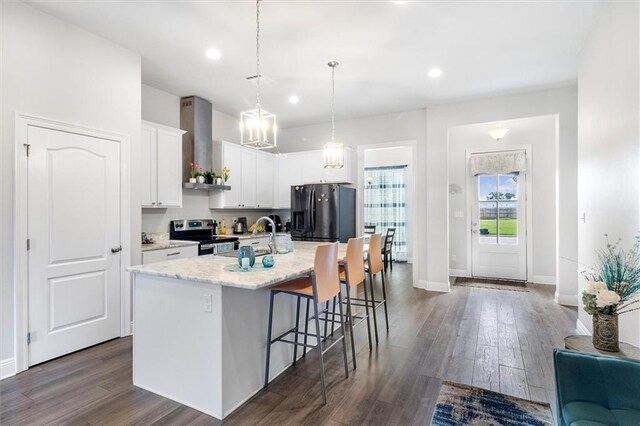 3225 Delaware Ave, Kenner, LA 70065 - kitchen featuring black refrigerator with ice dispenser, stainless steel range with electric stovetop, wall chimney exhaust hood, a sink, and a breakfast bar