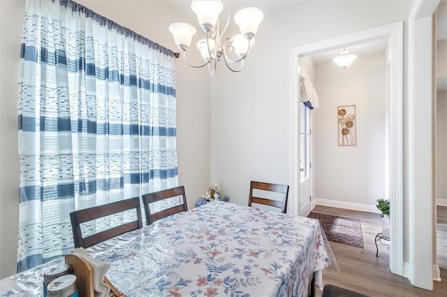 3225 Delaware Ave, Kenner, LA 70065 - dining room with wood finished floors, a chandelier, and baseboards