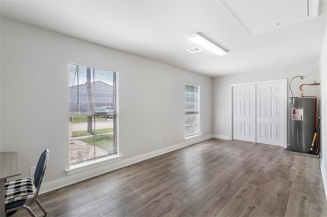 3225 Delaware Ave, Kenner, LA 70065 - unfurnished office with electric water heater, attic access, plenty of natural light, and wood finished floors