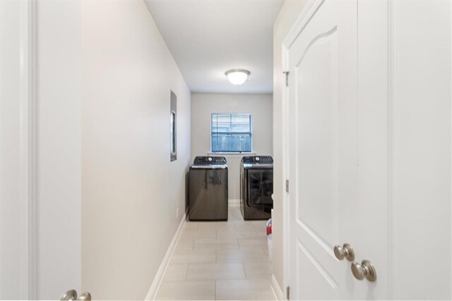 3225 Delaware Ave, Kenner, LA 70065 - hallway featuring washer and dryer, baseboards, and light tile patterned floors