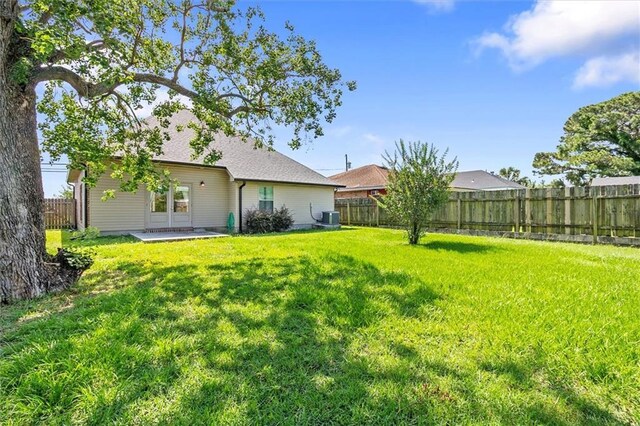 3225 Delaware Ave, Kenner, LA 70065 - rear view of property featuring central AC unit, a patio area, and roof with shingles