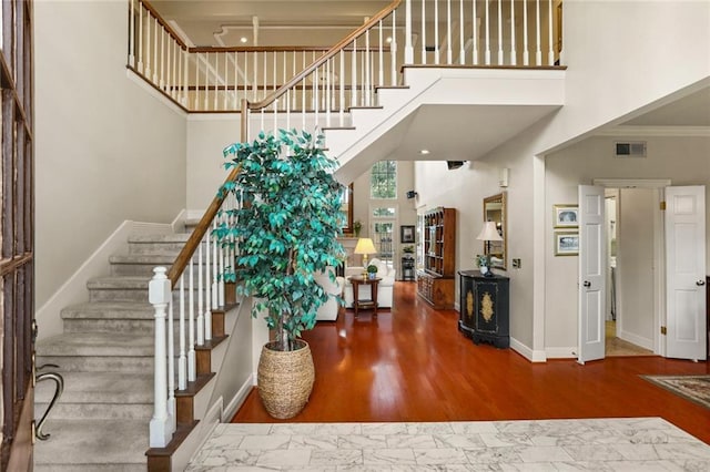137 Lakewood Estates Dr, New Orleans, LA 70131 - foyer featuring a high ceiling, stairway, baseboards, wood finished floors, and crown molding