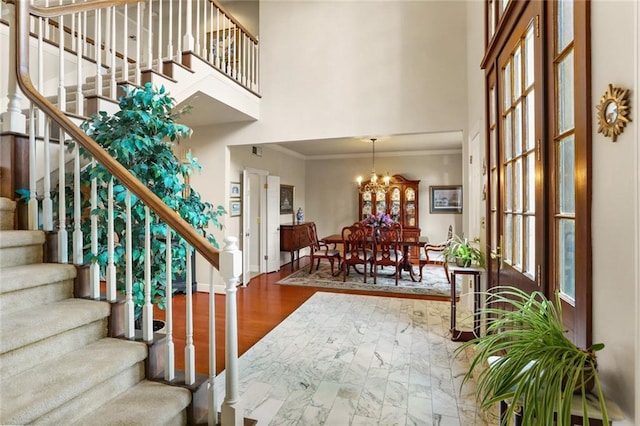 137 Lakewood Estates Dr, New Orleans, LA 70131 - entryway with ornamental molding, a towering ceiling, stairway, baseboards, and marble look tiles