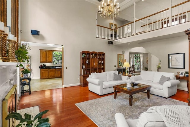 137 Lakewood Estates Dr, New Orleans, LA 70131 - living area with a fireplace, wood finished floors, plenty of natural light, and a high ceiling