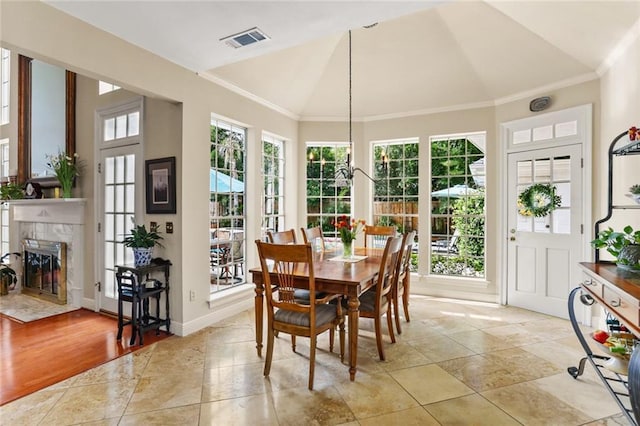 137 Lakewood Estates Dr, New Orleans, LA 70131 - dining room featuring lofted ceiling, crown molding, and a premium fireplace