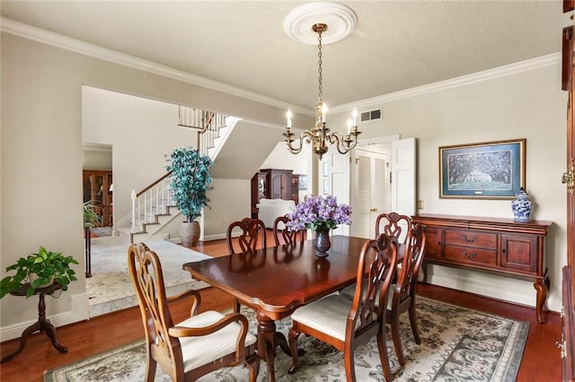 137 Lakewood Estates Dr, New Orleans, LA 70131 - dining space with stairway, wood finished floors, crown molding, baseboards, and a chandelier