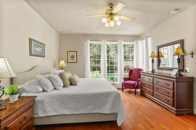 137 Lakewood Estates Dr, New Orleans, LA 70131 - bedroom featuring a textured ceiling, light wood-style flooring, and ceiling fan