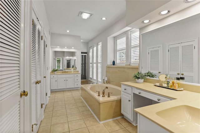 137 Lakewood Estates Dr, New Orleans, LA 70131 - full bathroom with a closet, tile patterned floors, recessed lighting, a garden tub, and two vanities