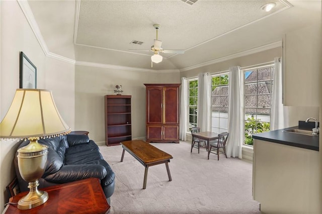 137 Lakewood Estates Dr, New Orleans, LA 70131 - living room with a tray ceiling, light carpet, crown molding, a ceiling fan, and a textured ceiling