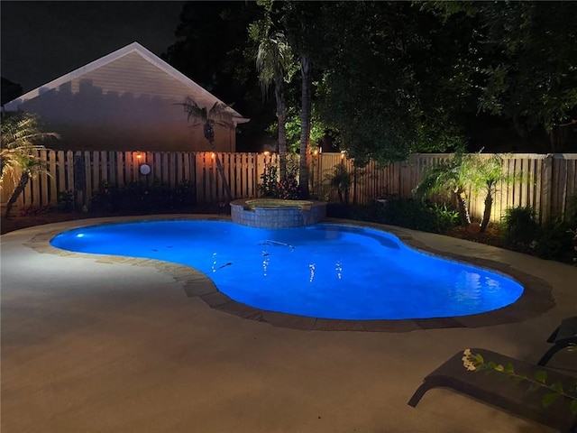 137 Lakewood Estates Dr, New Orleans, LA 70131 - pool at night featuring a fenced backyard, a patio area, and a pool with connected hot tub