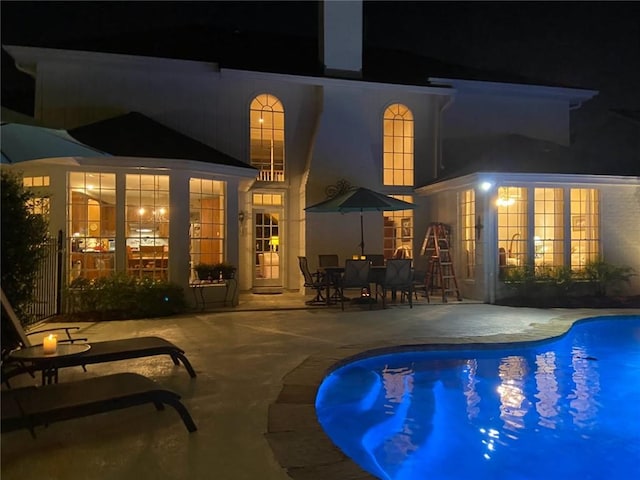 137 Lakewood Estates Dr, New Orleans, LA 70131 - pool at night with a patio area and an outdoor pool