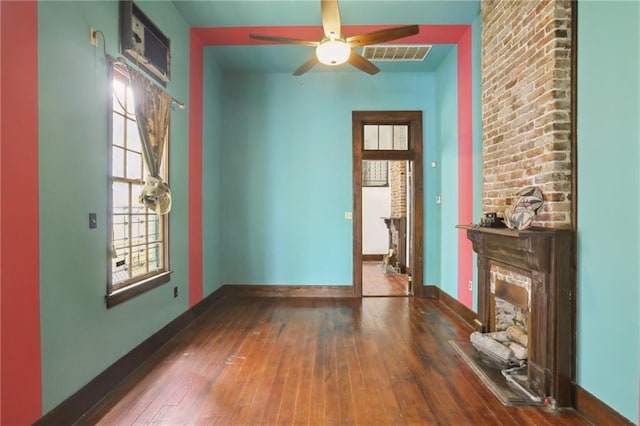 271214 Burgundy St, New Orleans, LA 70117 - empty room with wood-type flooring, ceiling fan, and a fireplace