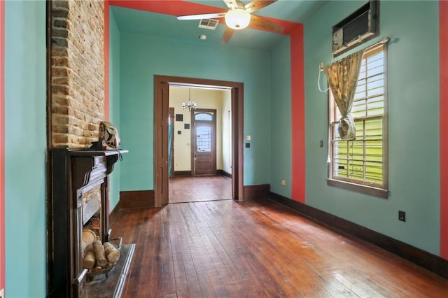271214 Burgundy St, New Orleans, LA 70117 - foyer entrance with hardwood / wood-style flooring, a ceiling fan, and a fireplace
