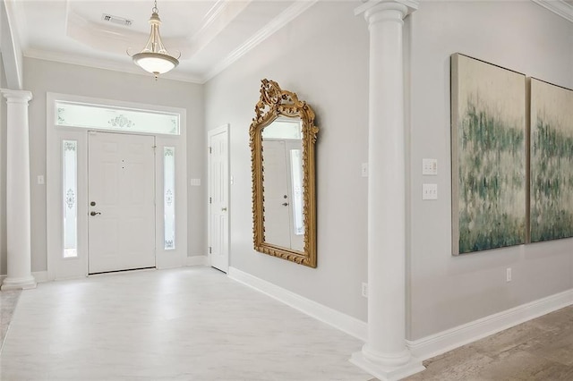 31057 Woodland Dr, Lacombe, LA 70445 - foyer featuring ornate columns, wood finished floors, ornamental molding, a raised ceiling, and baseboards