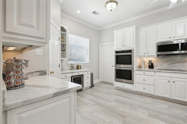 31057 Woodland Dr, Lacombe, LA 70445 - kitchen featuring stainless steel appliances, beverage cooler, white cabinets, ornamental molding, and open shelves