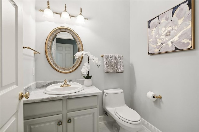 31057 Woodland Dr, Lacombe, LA 70445 - bathroom with vanity, toilet, marble finish flooring, and baseboards