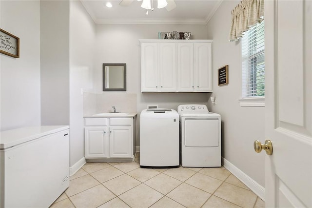 31057 Woodland Dr, Lacombe, LA 70445 - clothes washing area featuring cabinet space, washing machine and dryer, baseboards, ornamental molding, and light tile patterned floors
