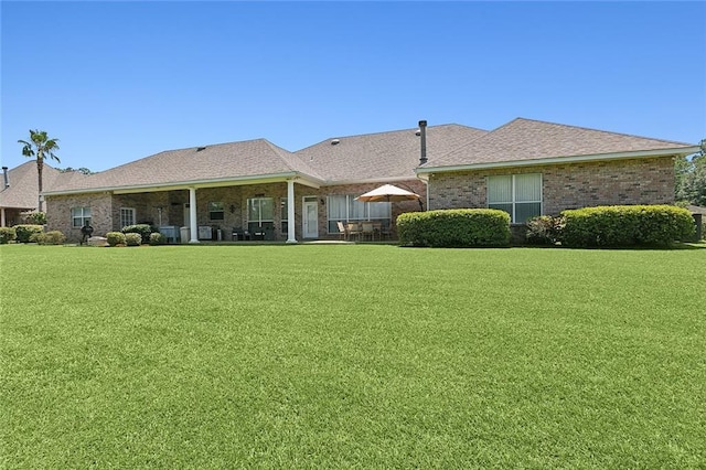 31057 Woodland Dr, Lacombe, LA 70445 - rear view of property with a yard and brick siding