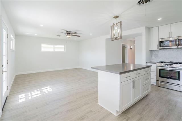 9004 Camille Ct, River Ridge, LA 70123 - kitchen with appliances with stainless steel finishes, light wood-style flooring, recessed lighting, white cabinets, and decorative backsplash