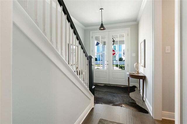 1641 Continental Dr, Covington, LA 70433 - foyer entrance featuring french doors, ornamental molding, stairs, baseboards, and dark wood-type flooring