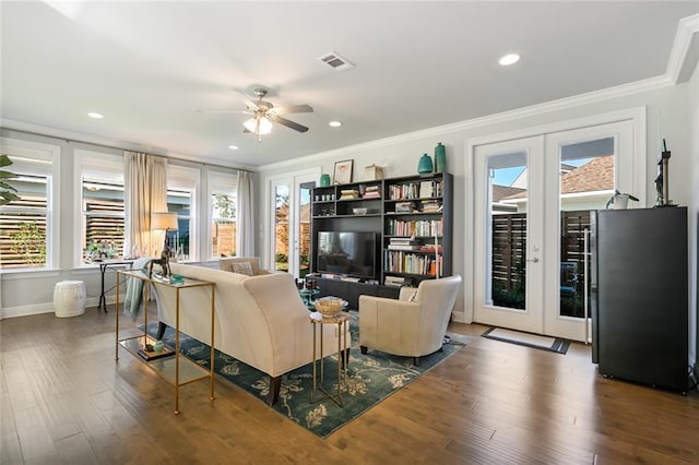 1641 Continental Dr, Covington, LA 70433 - living room with healthy amount of natural light, crown molding, ceiling fan, wood finished floors, and recessed lighting