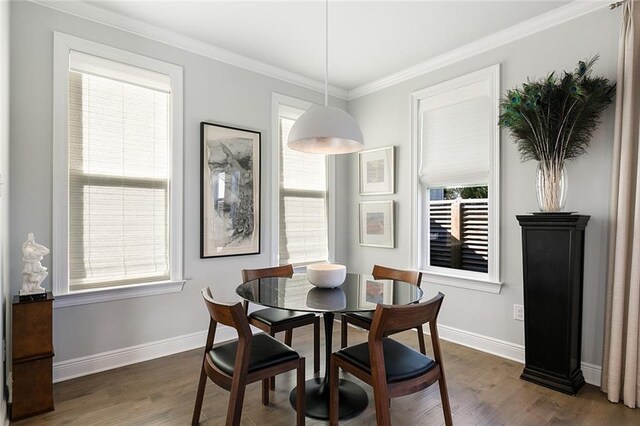 1641 Continental Dr, Covington, LA 70433 - dining room featuring dark wood-style floors, baseboards, plenty of natural light, and crown molding