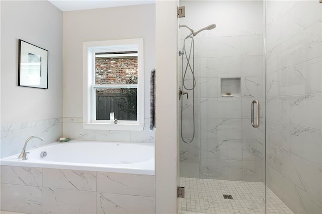 1641 Continental Dr, Covington, LA 70433 - bathroom featuring a bath and a marble finish shower