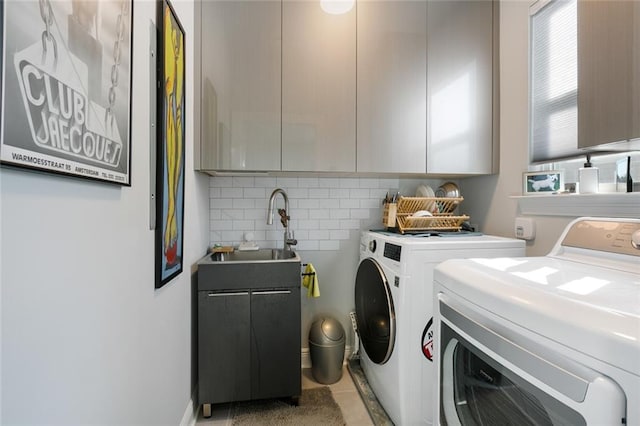 1641 Continental Dr, Covington, LA 70433 - laundry room featuring washer and dryer, cabinet space, and light tile patterned flooring