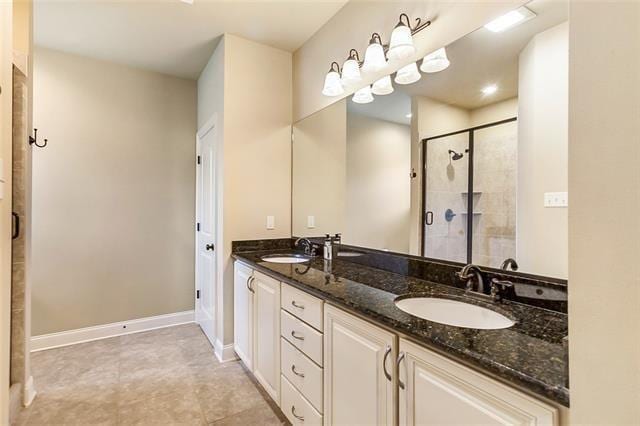 217 Coushatta Cir, Madisonville, LA 70447 - bathroom with a stall shower, double vanity, and baseboards