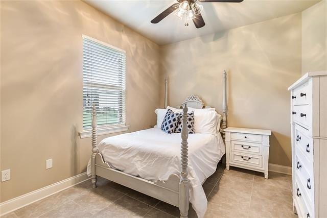217 Coushatta Cir, Madisonville, LA 70447 - bedroom with baseboards, light tile patterned flooring, and a ceiling fan