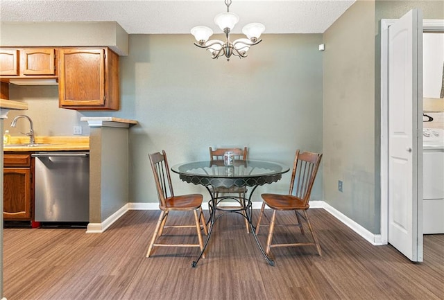 736 Village Rd Unit A, Kenner, LA 70065 - dining area with wood finished floors, a chandelier, and baseboards