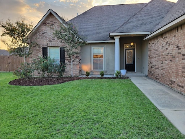 40153 Maison Lafitte Blvd, Ponchatoula, LA 70454 - view of front of home featuring a shingled roof, brick siding, and stucco siding