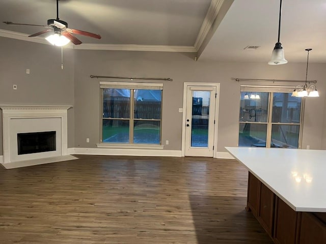 40153 Maison Lafitte Blvd, Ponchatoula, LA 70454 - unfurnished living room with crown molding, dark wood finished floors, a ceiling fan, a fireplace with flush hearth, and a chandelier