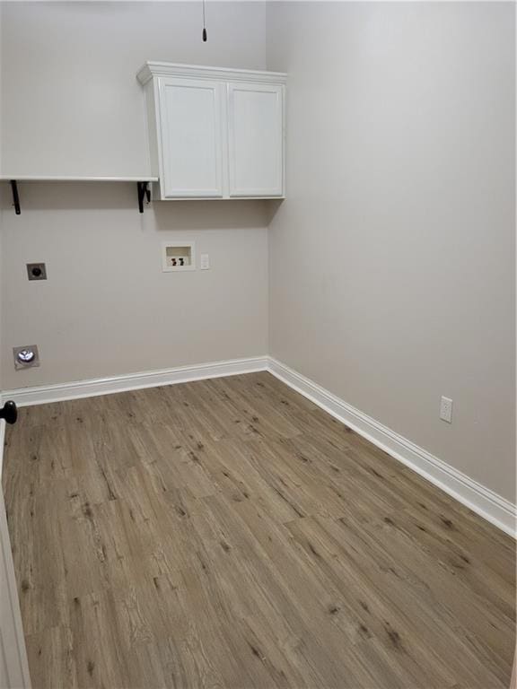 40153 Maison Lafitte Blvd, Ponchatoula, LA 70454 - washroom with electric dryer hookup, wood finished floors, hookup for a washing machine, and cabinet space