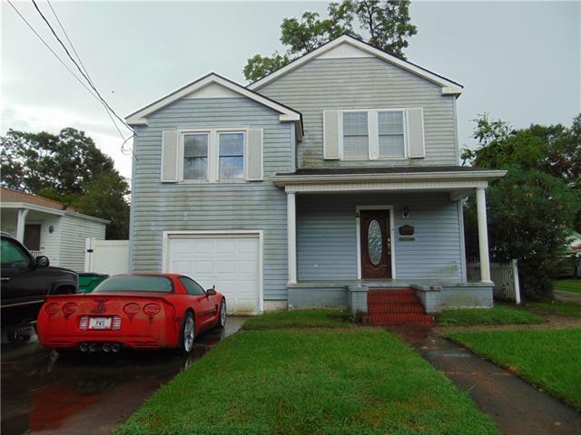 3008 Beaulieu St, Metairie, LA 70001 - traditional-style house with a garage, a porch, and a front lawn