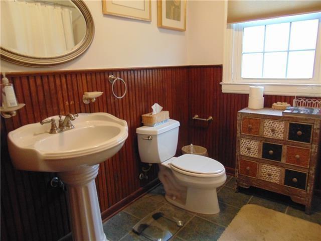 3008 Beaulieu St, Metairie, LA 70001 - bathroom featuring wainscoting, toilet, and tile patterned flooring