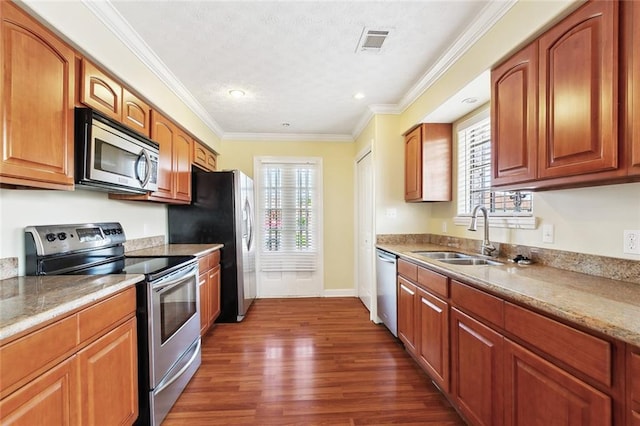 5736 E Louis Prima Dr, New Orleans, LA 70128 - kitchen with appliances with stainless steel finishes, a sink, dark wood-style flooring, ornamental molding, and light countertops