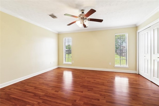 5736 E Louis Prima Dr, New Orleans, LA 70128 - unfurnished bedroom featuring crown molding, wood finished floors, baseboards, ceiling fan, and a closet