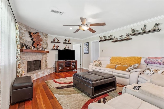 1417 Washington Ct, Slidell, LA 70458 - living area featuring ceiling fan, ornamental molding, wood finished floors, and a stone fireplace