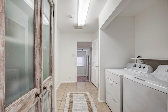 401 Hesper Ave, Metairie, LA 70005 - laundry room featuring separate washer and dryer, light tile patterned floors, and baseboards