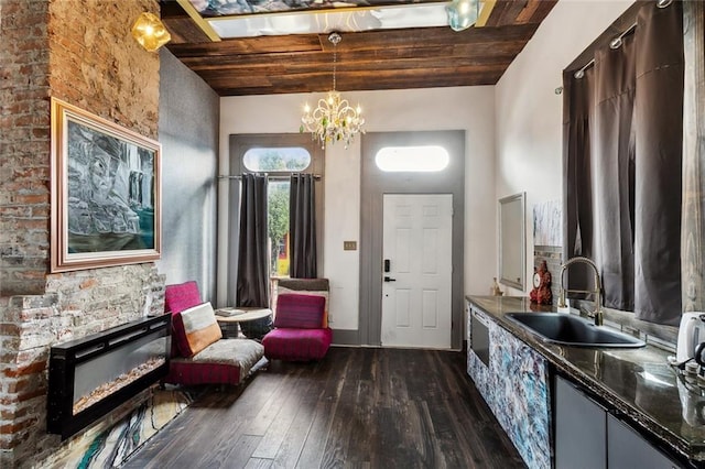 111214 Touro St, New Orleans, LA 70116 - foyer featuring dark wood-style flooring, wooden ceiling, a chandelier, and a glass covered fireplace