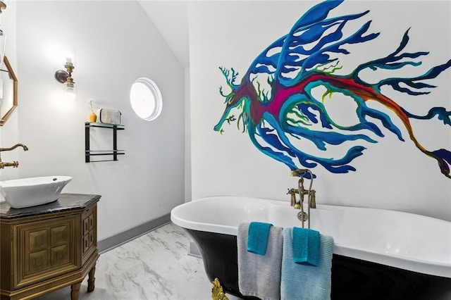 111214 Touro St, New Orleans, LA 70116 - bathroom with marble look tile flooring, vanity, a freestanding bath, and lofted ceiling