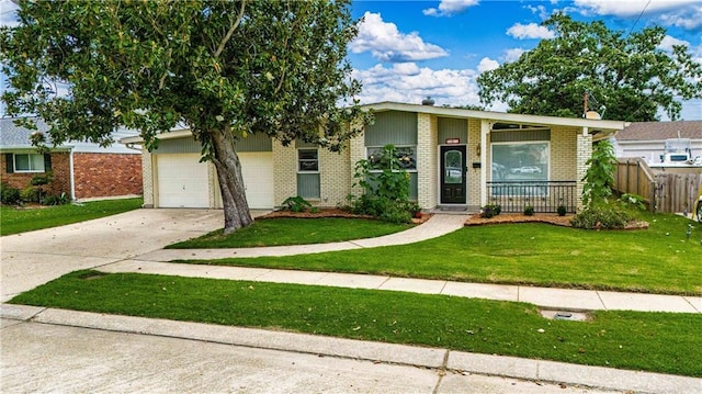 4401 Apollo Dr, Metairie, LA 70003 - view of front of property with brick siding, concrete driveway, and a garage