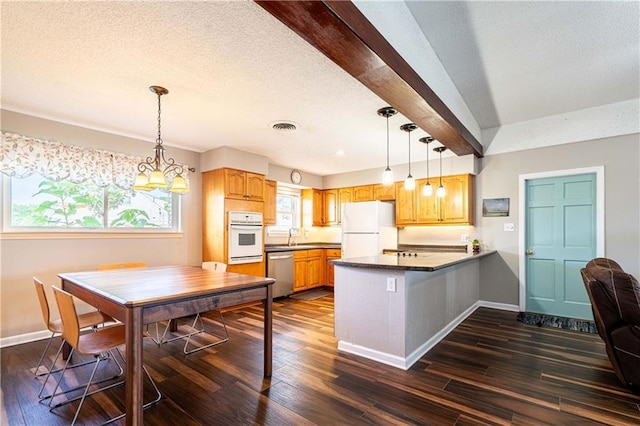 4401 Apollo Dr, Metairie, LA 70003 - kitchen with white appliances, a peninsula, baseboards, dark wood-style flooring, and dark countertops
