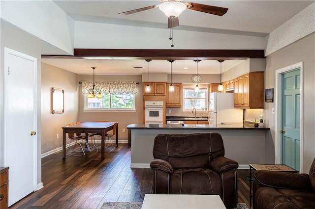 4401 Apollo Dr, Metairie, LA 70003 - living room with dark wood-style floors, ceiling fan, baseboards, and beamed ceiling